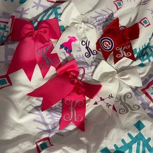 6- Hair bow initial “K” white, pink and red.